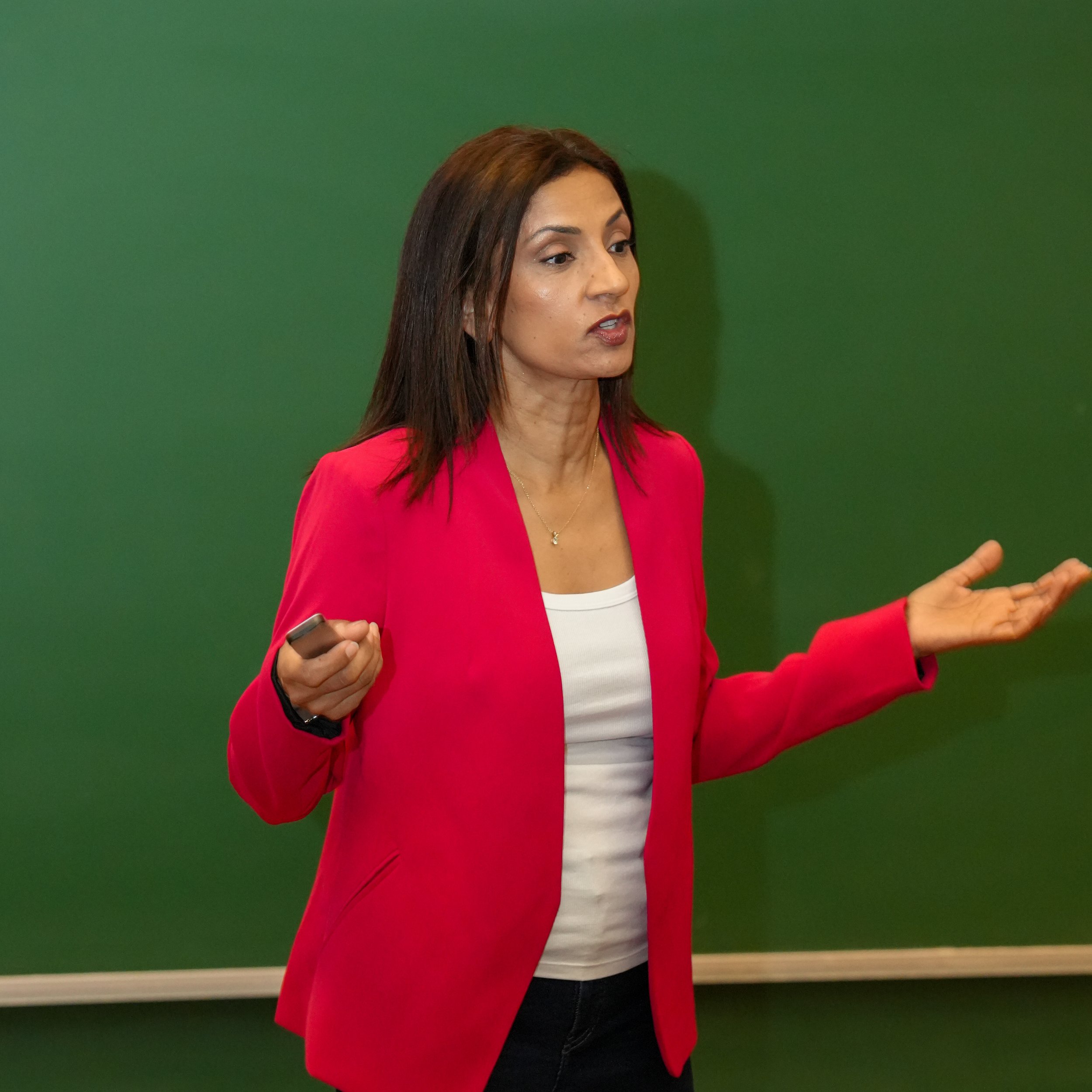 Poornima speaking in an auditorium.