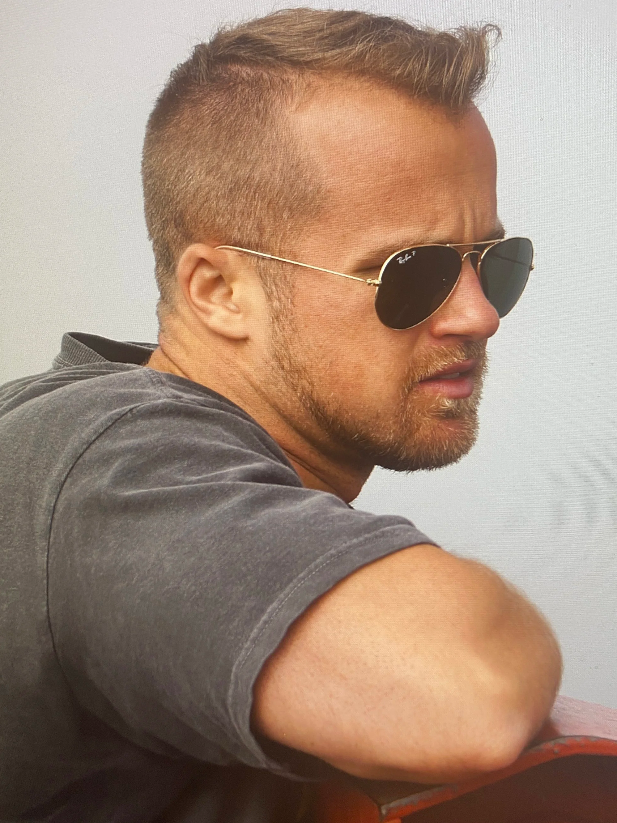 Man with sunglasses resting on the red gate