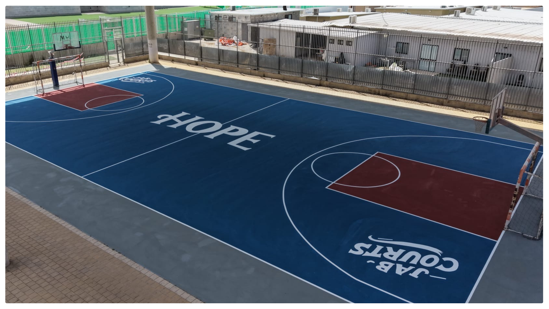 Renovated outdoor basketball court by JAB Courts featuring bold HOPE message, creating an inspiring and safe space for youth and community play