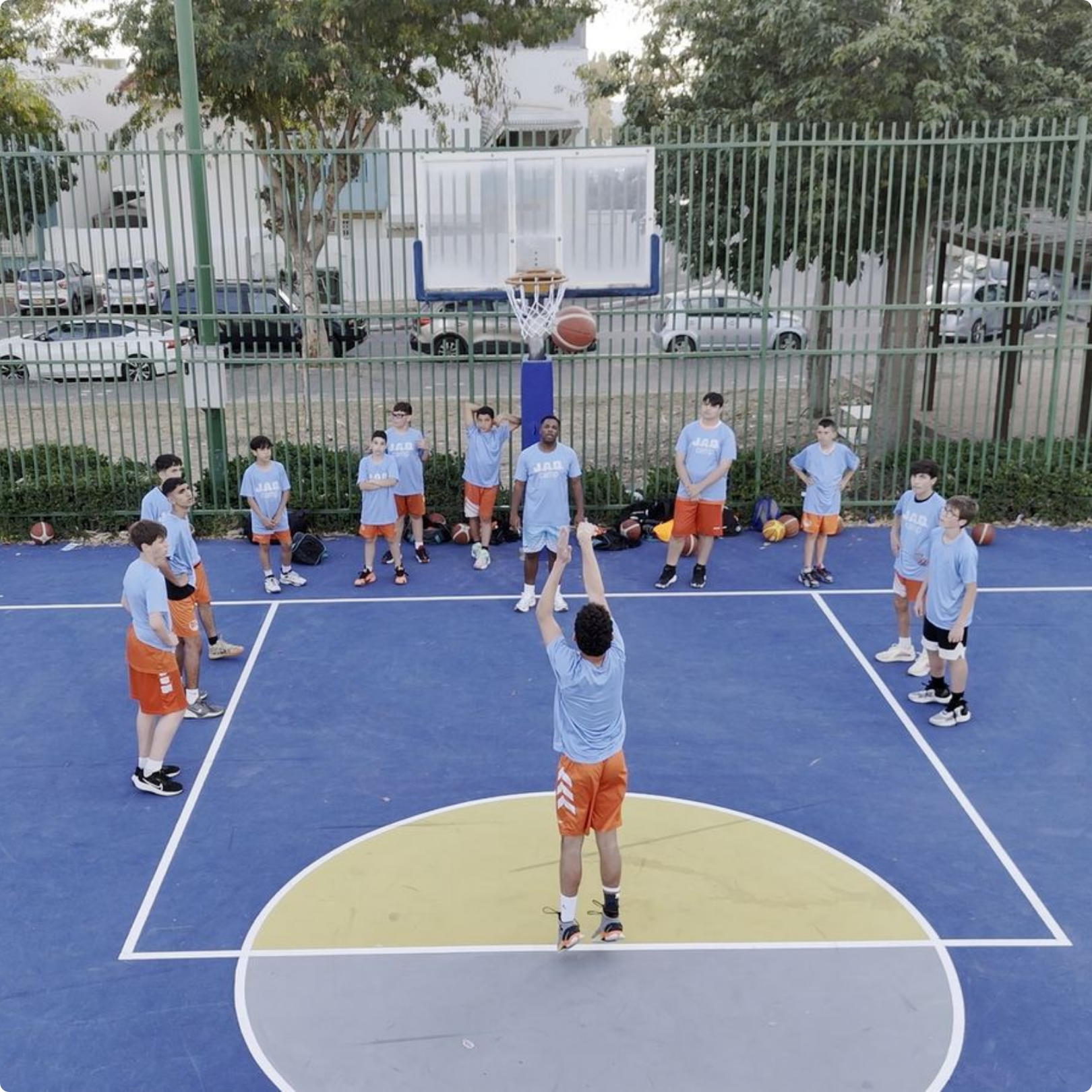 Outdoor youth basketball game at JAB Courts renovated court creating safe spaces for kids to play, grow, and connect