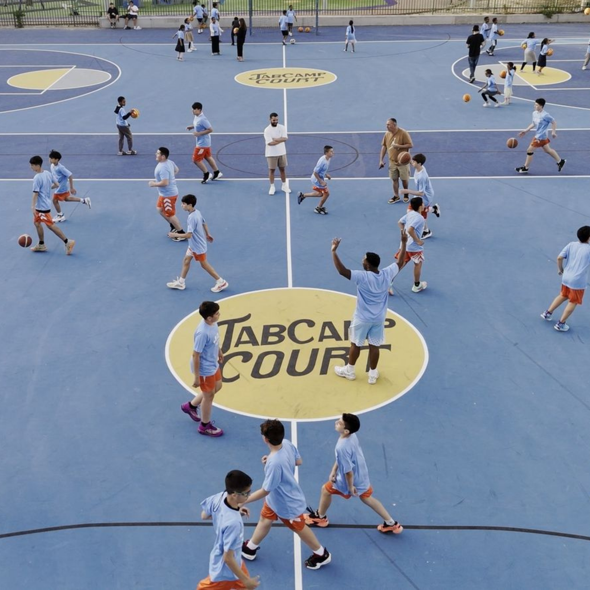Kids participating in JAB Camp basketball program on renovated court, building teamwork, confidence, and community through youth sports