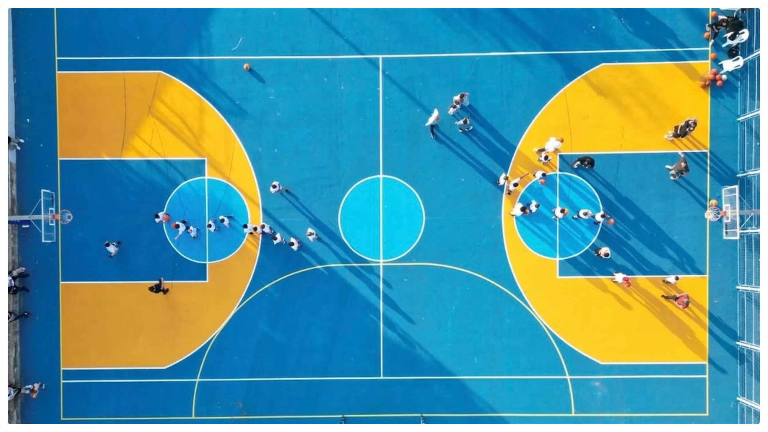 Colorful outdoor basketball court by JAB Courts designed for community play and youth engagement