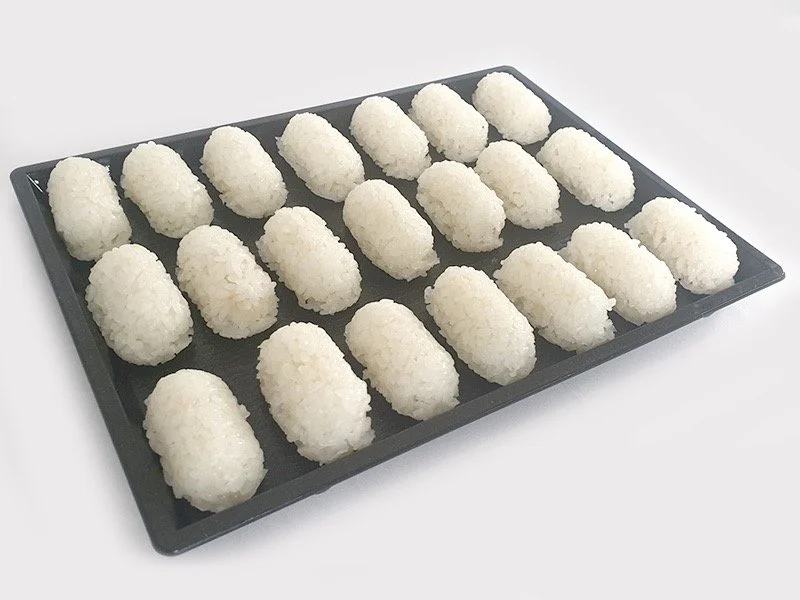 Tray of sushi on a black rectangular platter with multiple rice balls