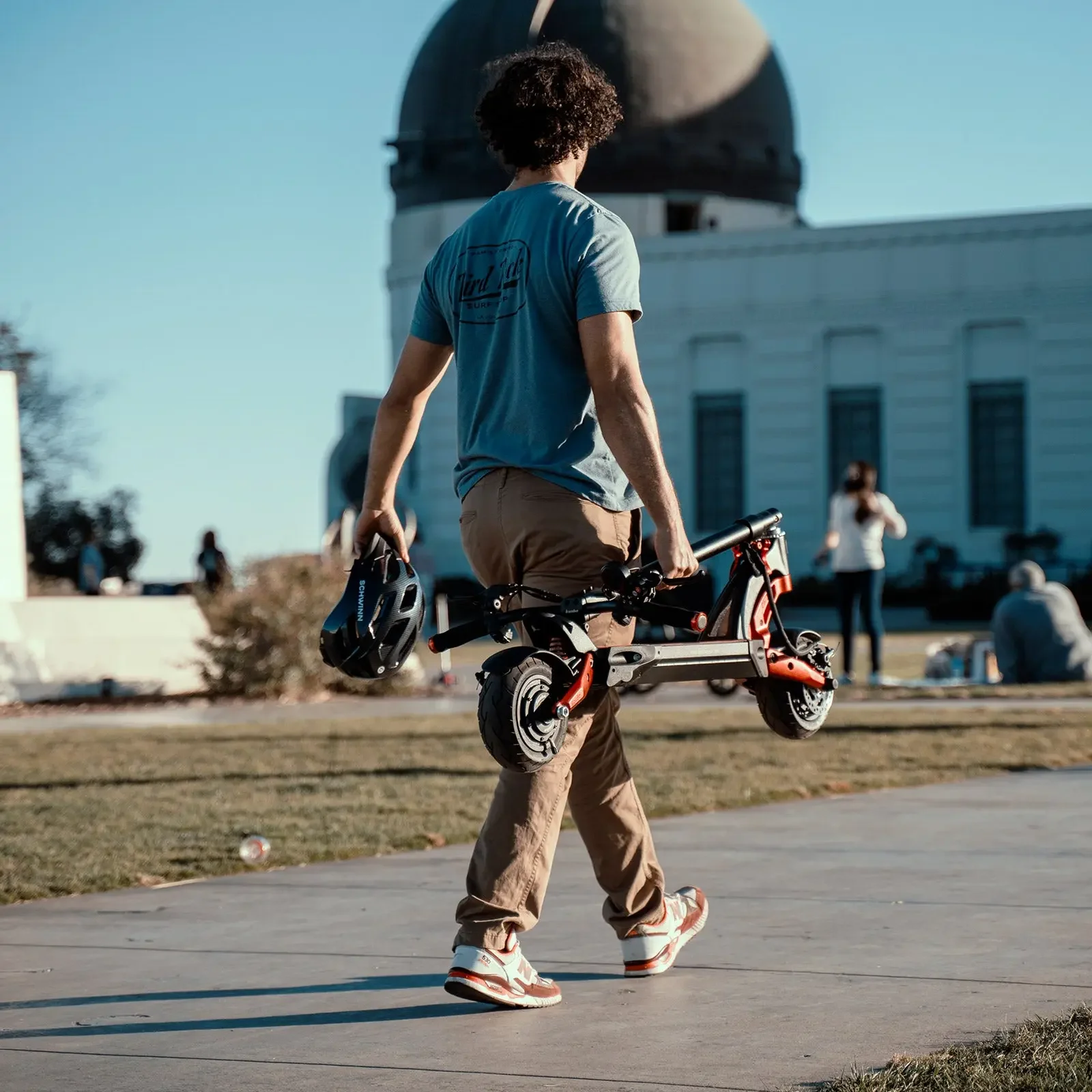 kaabo-mantis-8-electric-scooter-folded-man-walking.jpg.webp