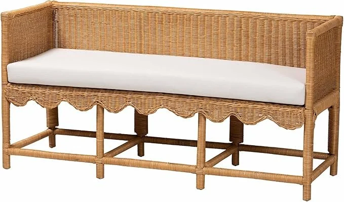Wicker bench with white cushion on a white background.
