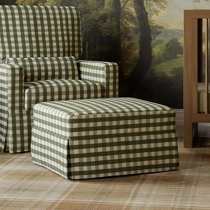 A green and white checkered armchair with matching ottoman in a living room with a nature-themed mural wall and a wooden side table.
