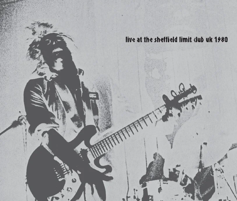 A black-and-white image of a musician playing an electric guitar during a live performance at Sheffield Limit Club in the UK, 1980.