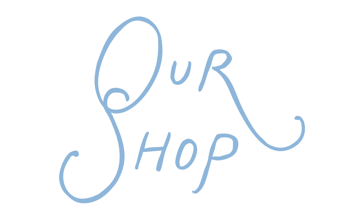 Handwritten sign reading 'Our Shop' with cursive lettering in blue ink.