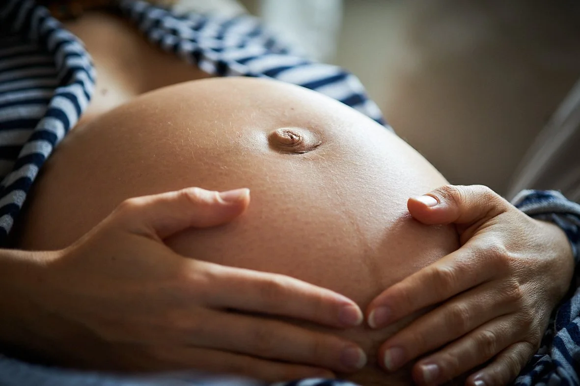Mutter berührt Babybauch