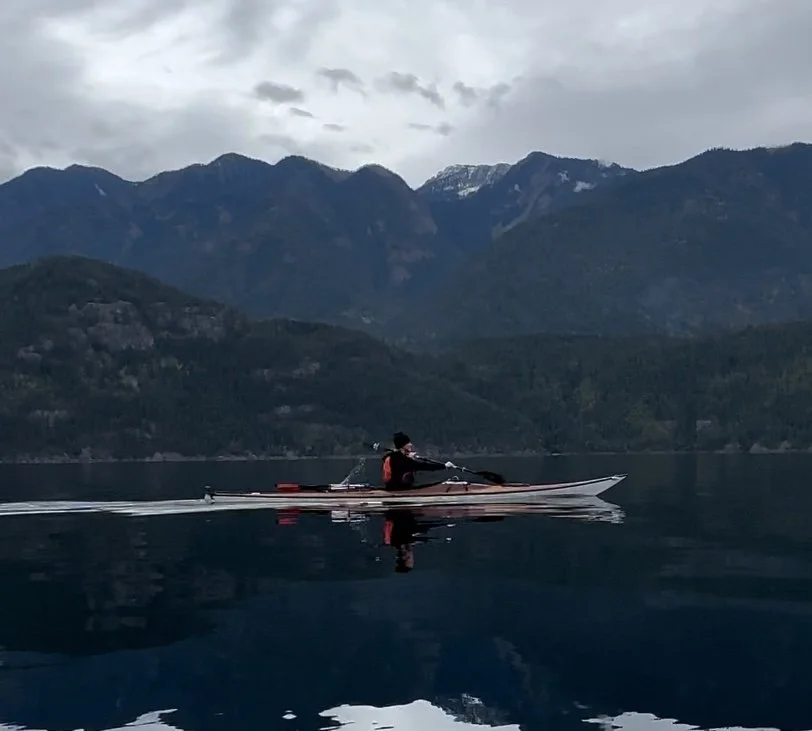 paddling on Slocan Lake with Selkirks reflecting in the background.jpeg