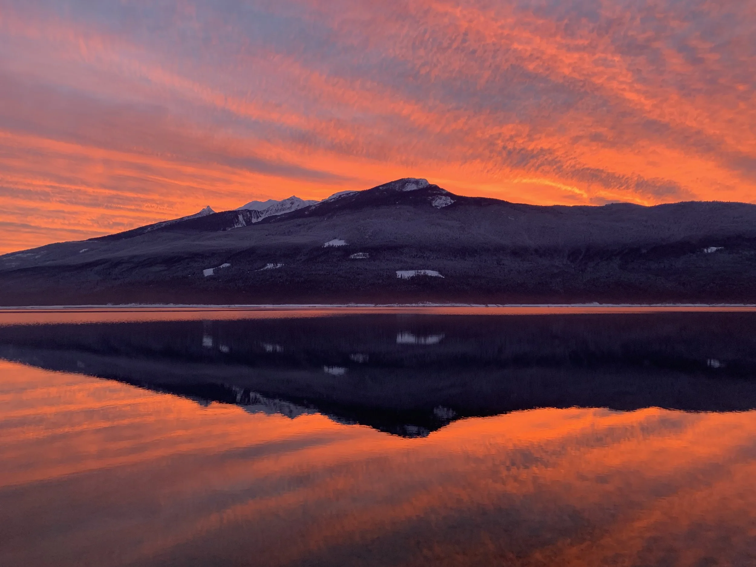 a fiery sunset behind Saddle Mountain 