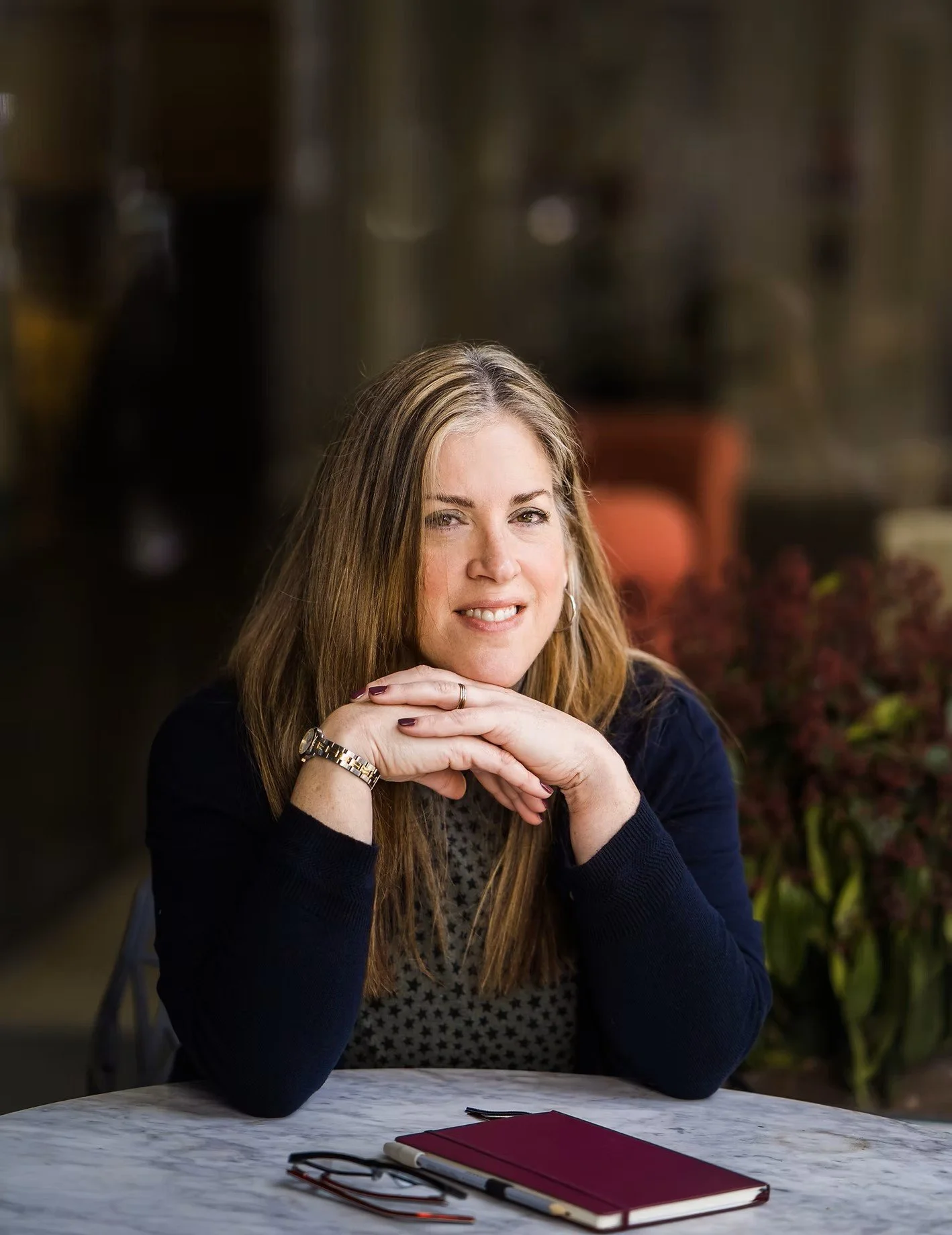 Clair Neill, psychotherapist seated at a table