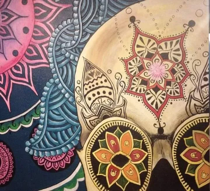 Colorful, detailed artwork featuring a butterfly with decorative patterns on its wings, surrounded by vibrant floral and geometric designs.