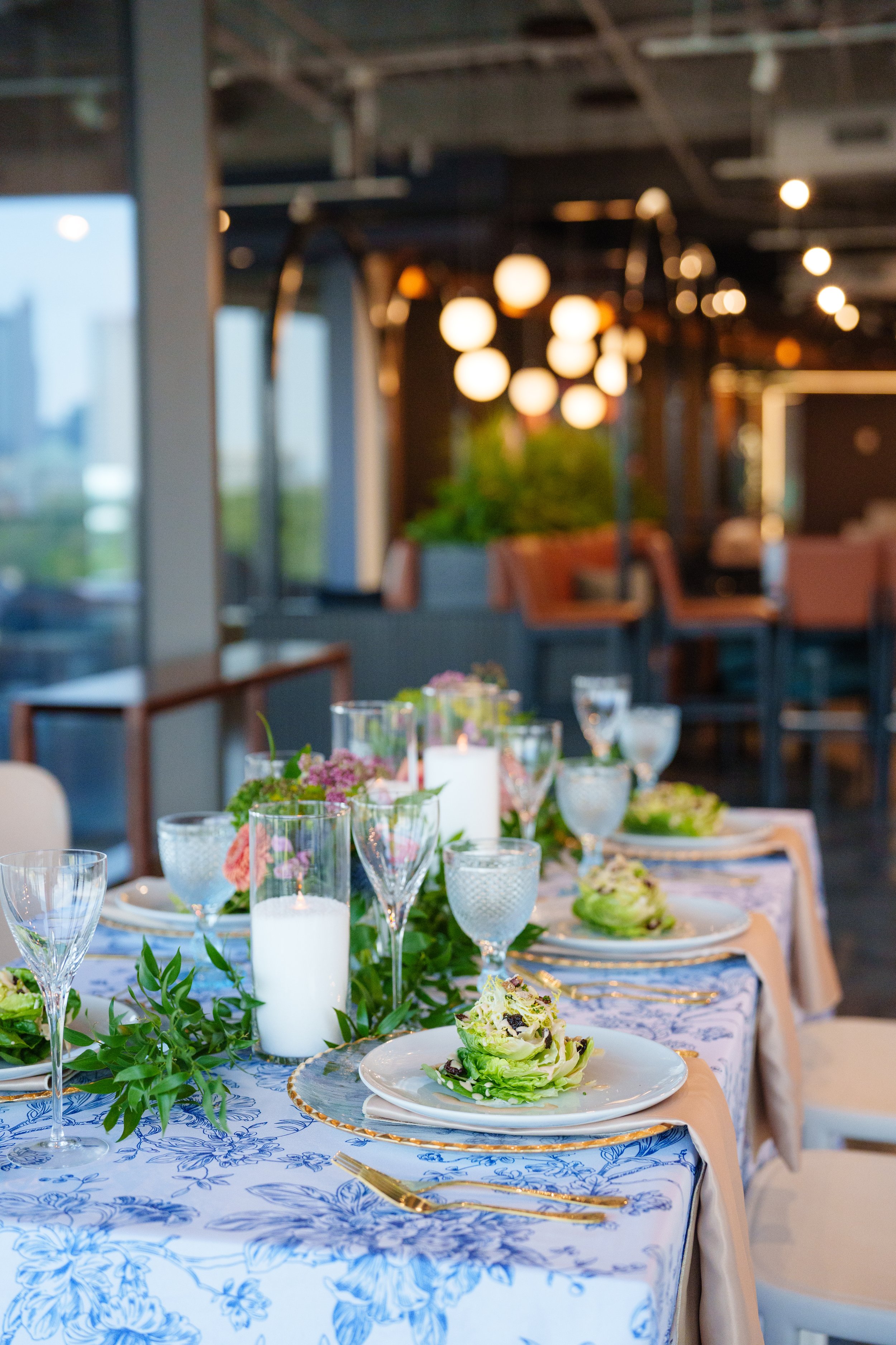 Beautifully plated salad course at an elegant Columbus, Ohio wedding reception, surrounded by candlelight and sophisticated table details. Photography: Nicole Dixon Photographic.
