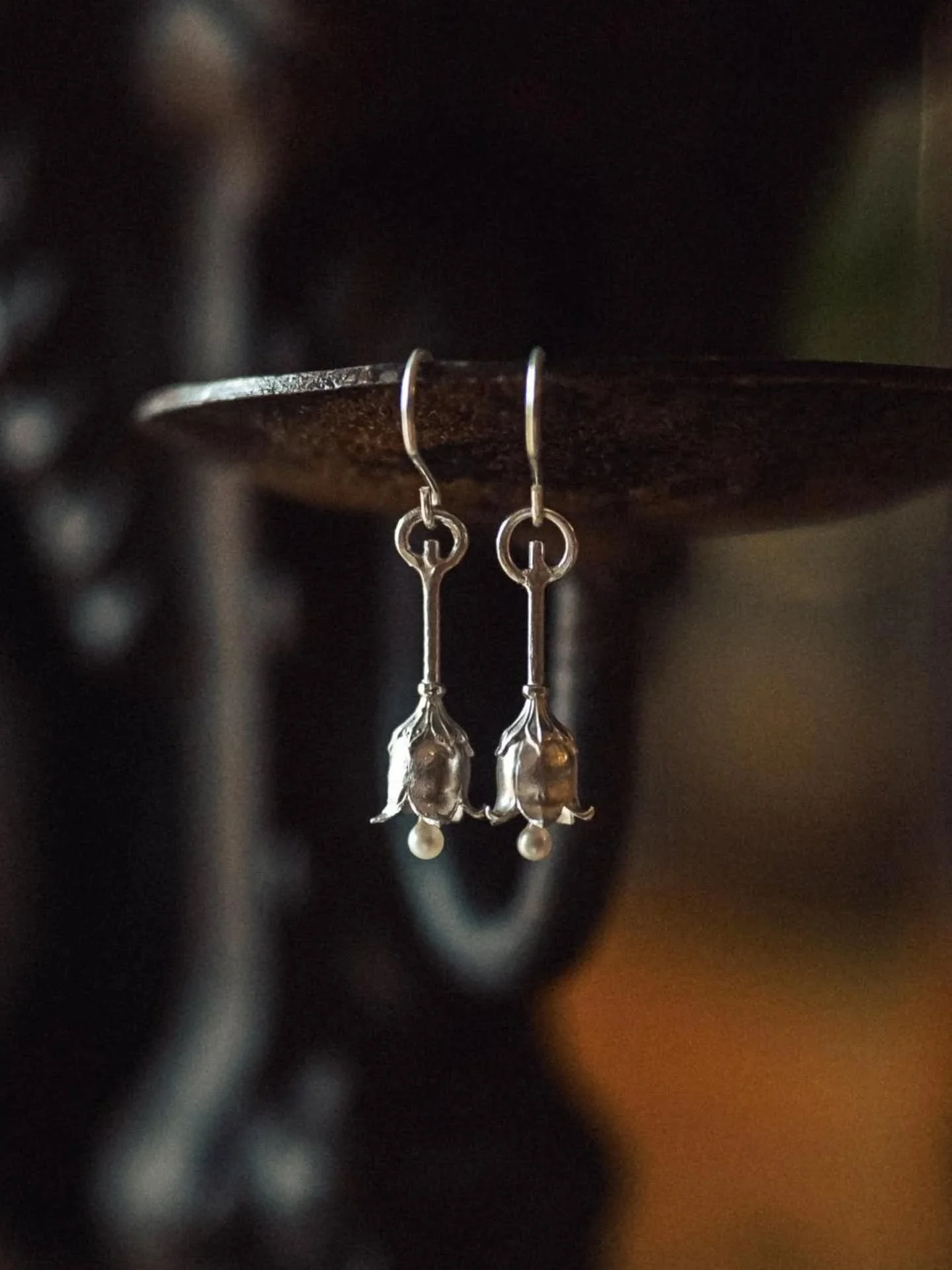 Lily of the valley has long held a place in the language of mourning and remembrance, its small bell-shaped flowers often carrying associations of humility, return, tenderness, and the quiet hope of being reunited with those we have lost.

Pearls, in