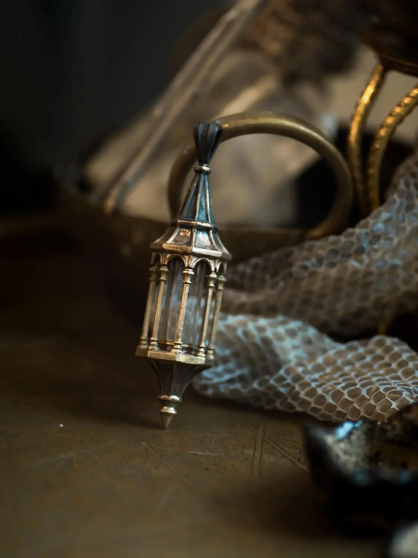 The gothic lantern reliquary in Altar size in bronze. 
I am working on a kind of "lamp post" for this item that can then hold the reliquary upright under a glass dome to be more of an object for home rather than a worn item.