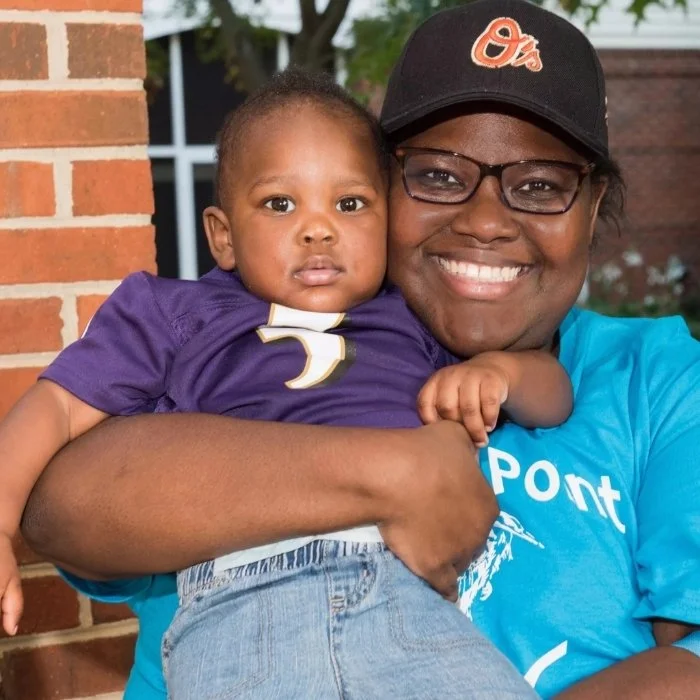 Mother holding baby and smiling