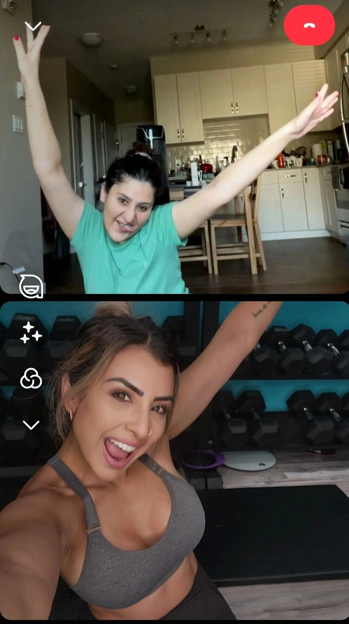 Two women in workout gear taking selfies in a gym, both smiling and having fun.