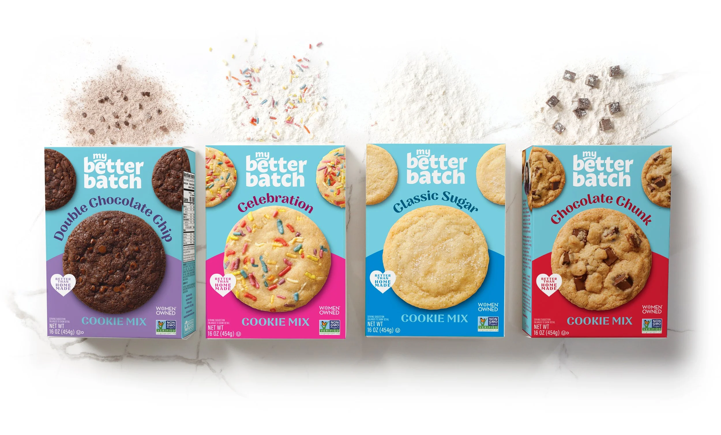 Four boxes of cookie mix flavored products, each with a different cookie: chocolate chip, celebration with rainbow sprinkles, classic sugar, and chocolate chunk, arranged in a row on a white surface with scattered cookie ingredients above.