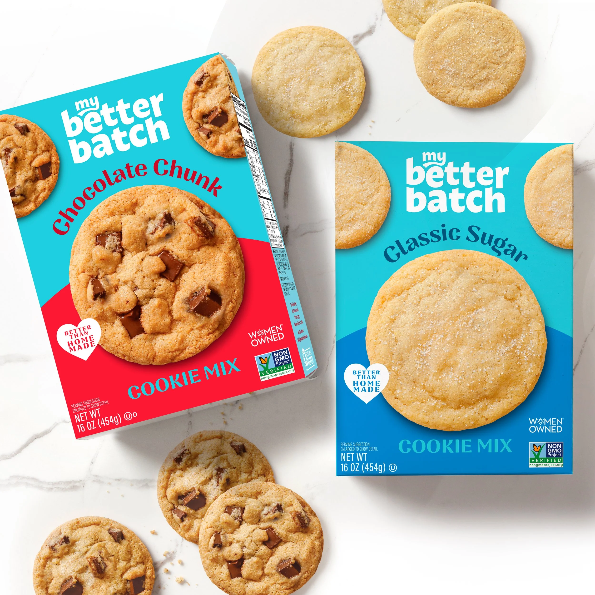 Multiple chocolate chip cookies arranged on a white surface, with two cookie packages partially visible featuring blue and red labels.