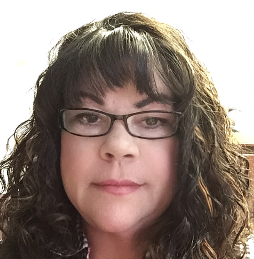 A woman with curly dark hair wearing glasses and light makeup, smiling softly. Bobbie Blair, Hospice, home health, revenue, QAPI
