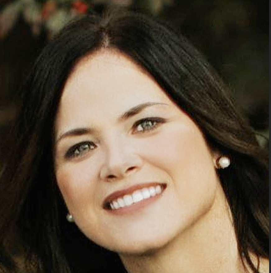 A woman with long dark hair smiling outdoors, wearing pearl earrings. Libbi Thompson, Hospice, home health, revenue, QAPI