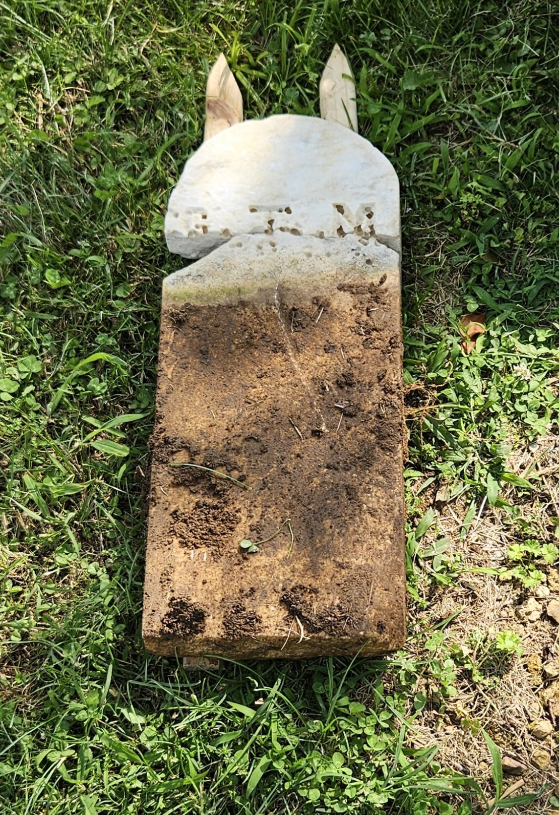 A footstone before cleaning