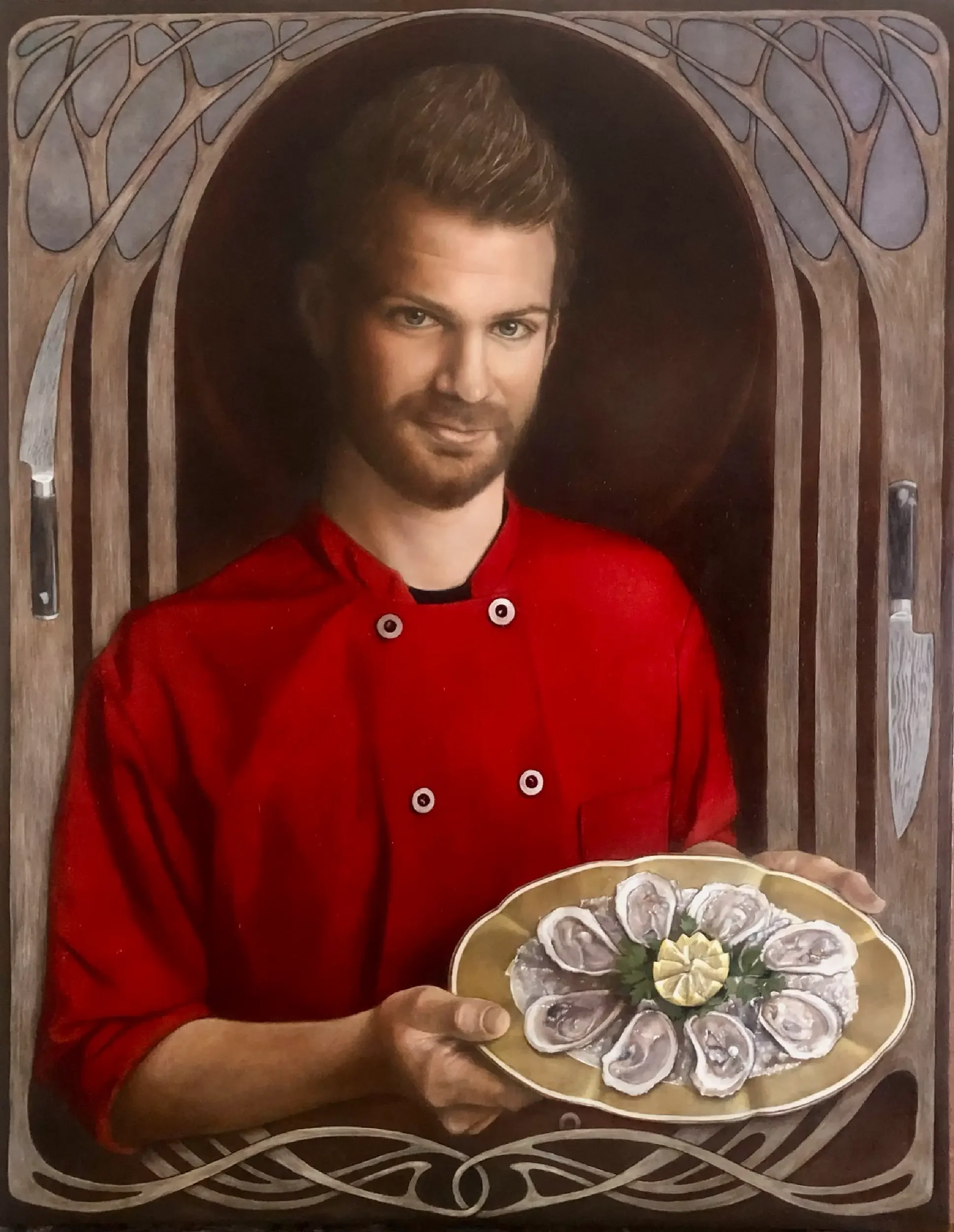 A person in a red culinary uniform holding a platter with a sliced oyster dish, with a decorative wooden frame around them.
