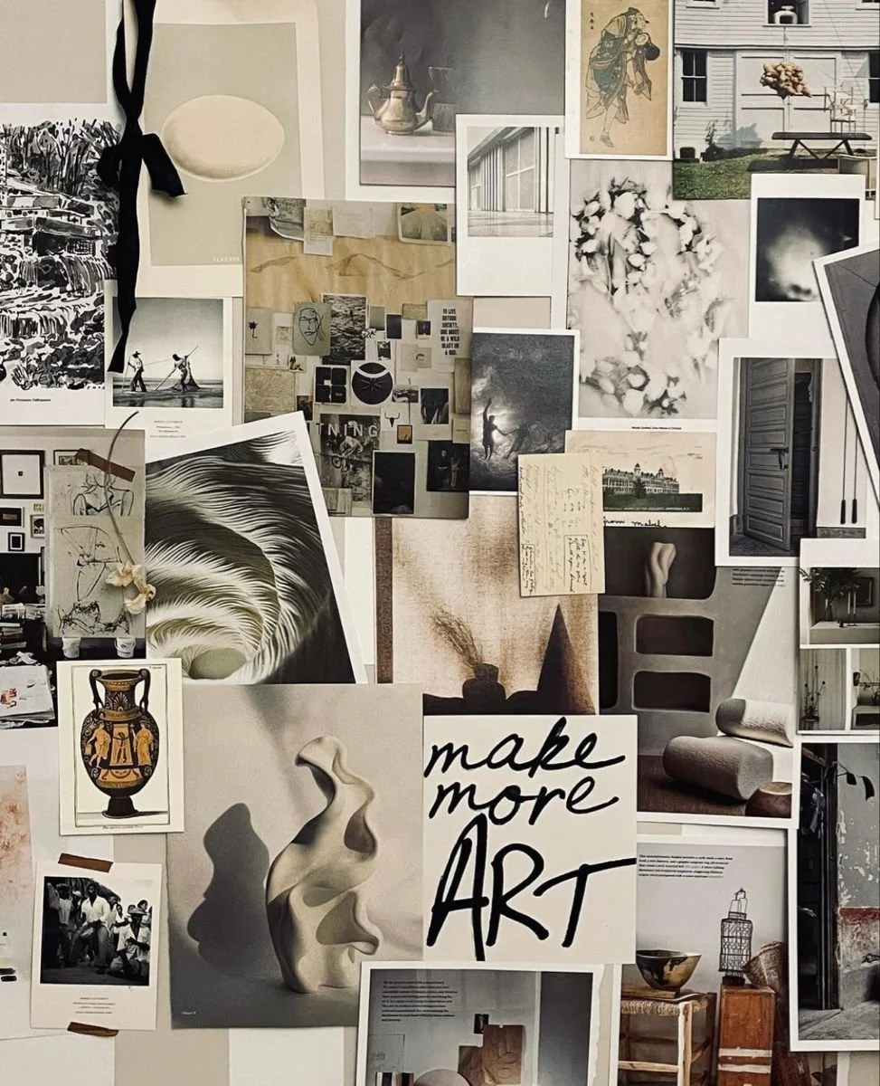 A collage of various black and white and color photographs, illustrations, and notes arranged on a wall, with a prominent sign that says 'make more ART' in black cursive lettering.