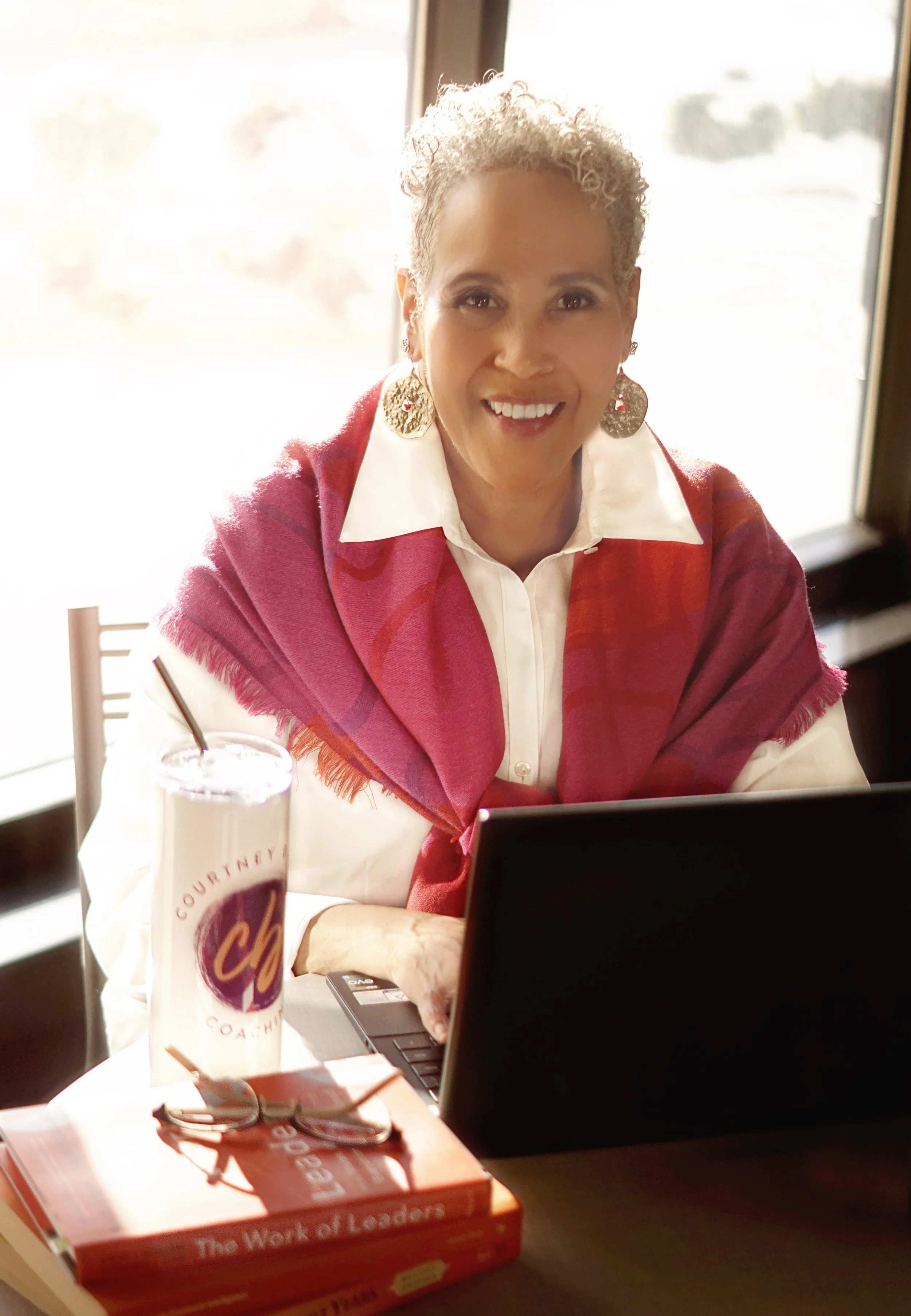 Courtney Burton smiling at the camer from behing her computer