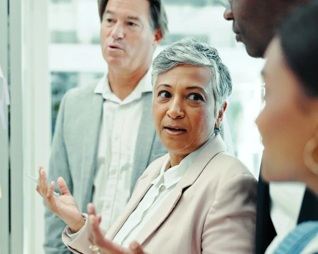 Executive woman asking team for direction