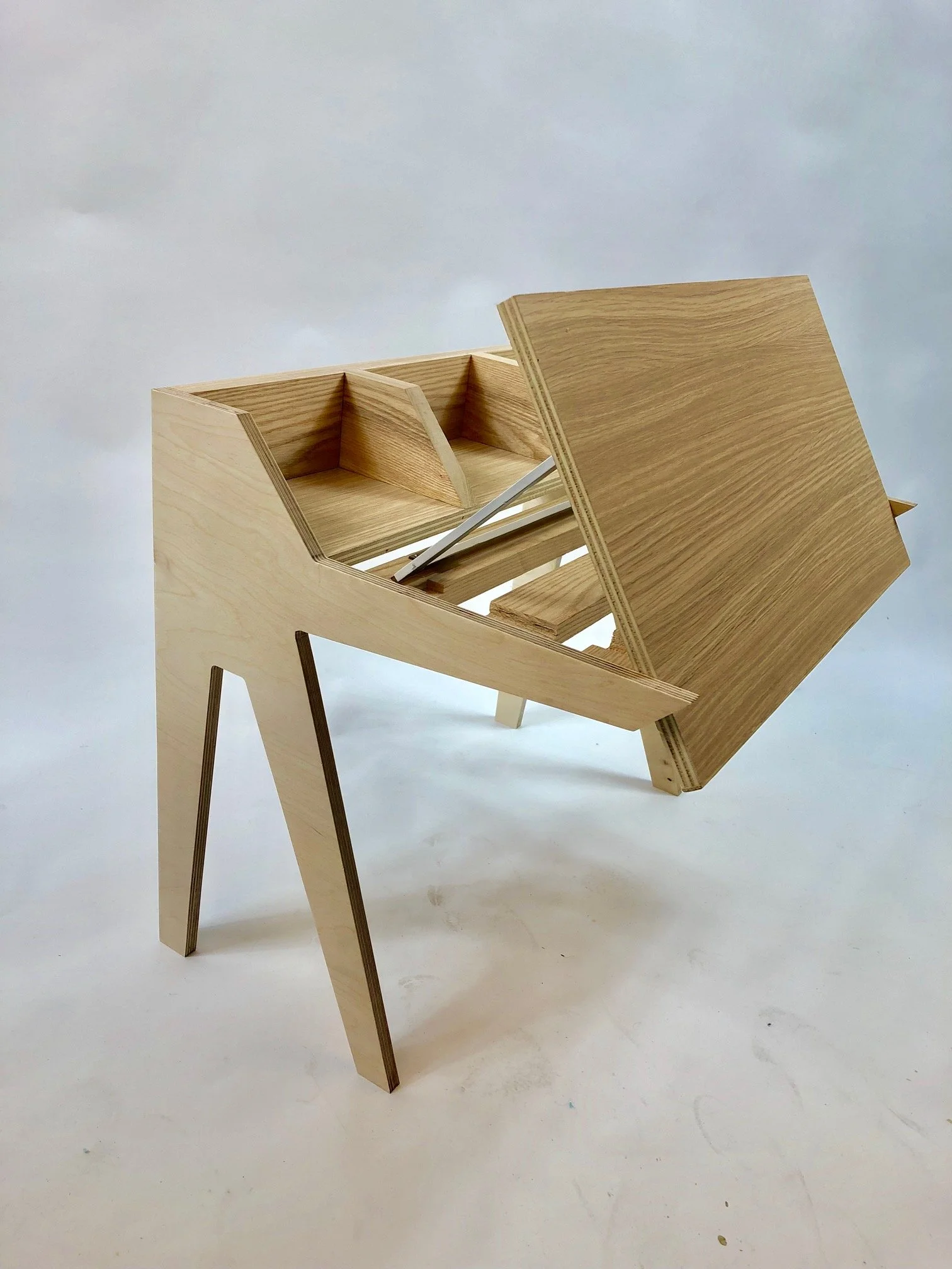 The tilting mechanism slots 
seamlessly into a chiseled-out 
groove to allow the working surface 
to fold down flush against the desks 
profile.
