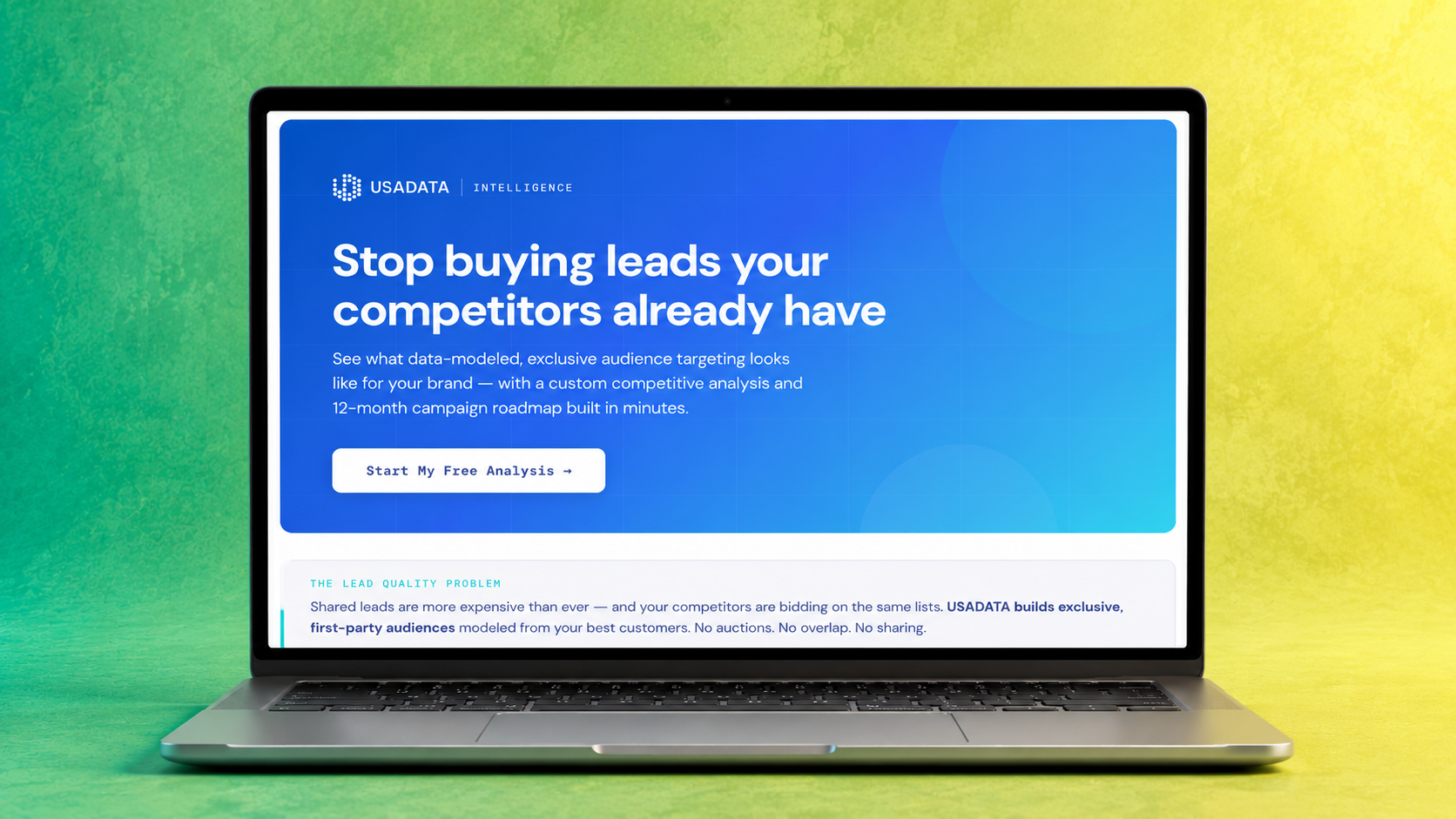 A laptop displaying a website for USADATA with a blue background, white text, and a call-to-action button that says "Start My Free Analysis." The laptop is on a surface with a colorful green-to-yellow gradient background.