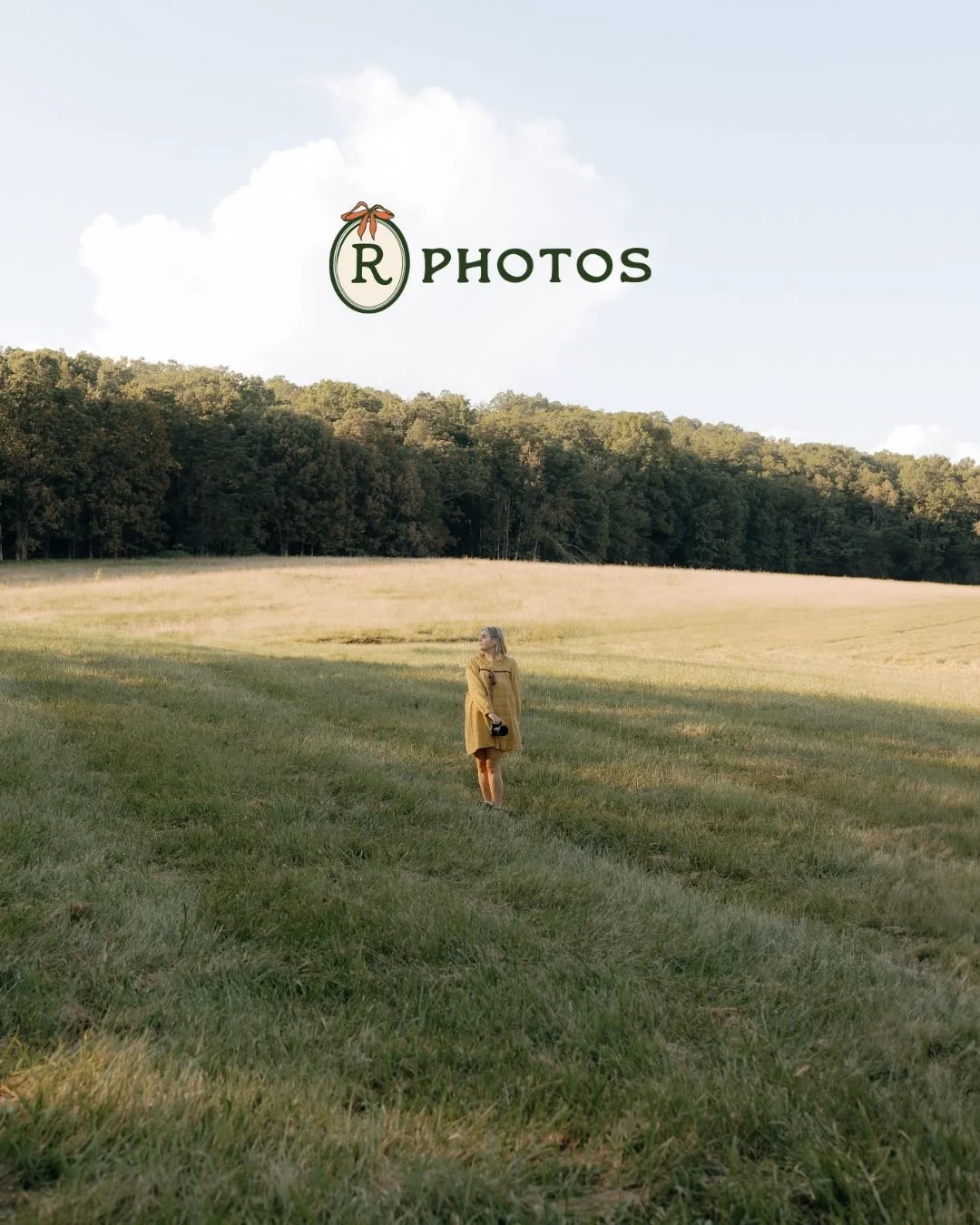 Soft editorial portrait of a blonde woman in a mustard dress standing in a Tennessee field at golden hour, low-angle perspective with open sky