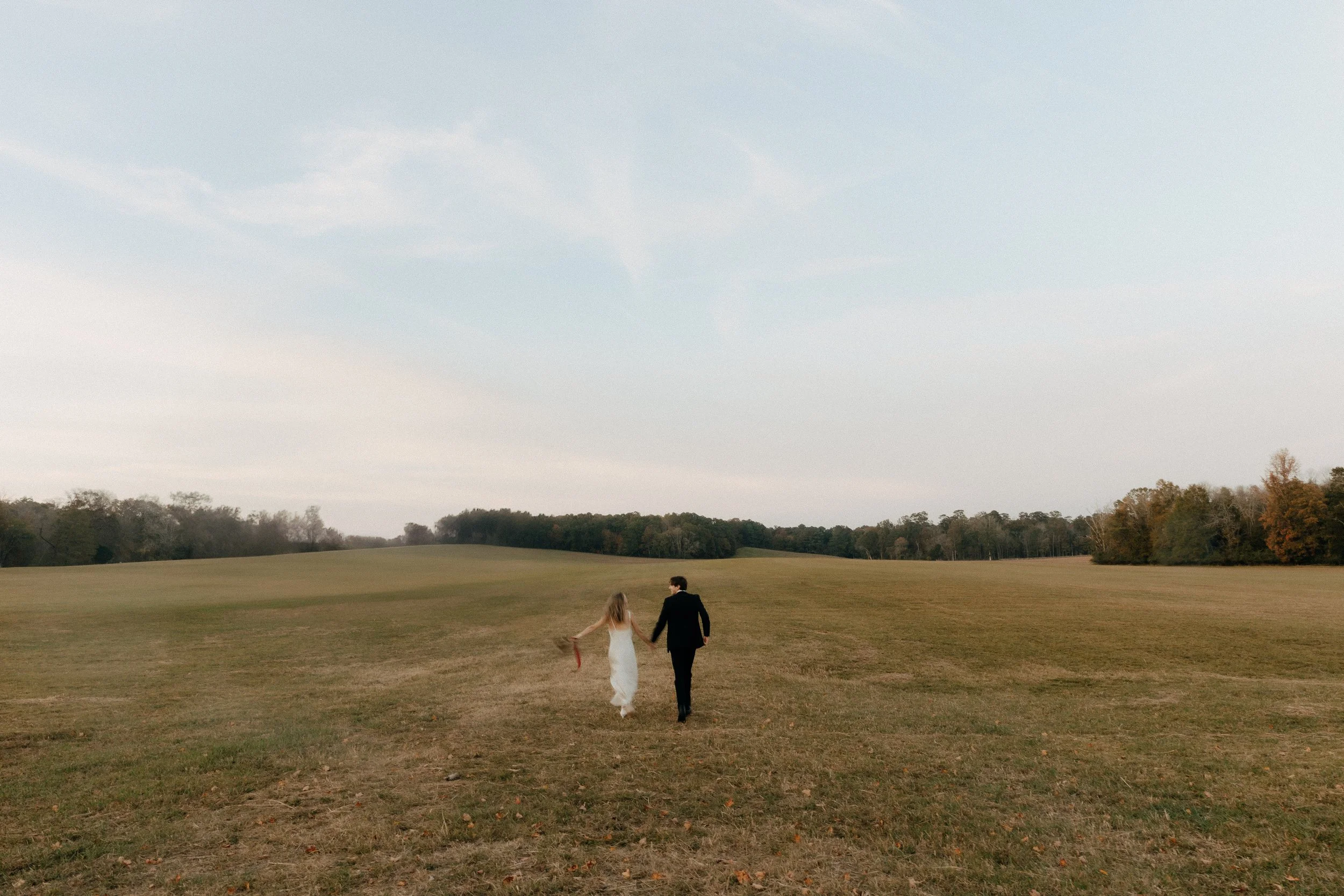 Bride and groom running in field at sunset after elopement ceremony in North Georgia - Chattanooga Tennessee elopement photographer