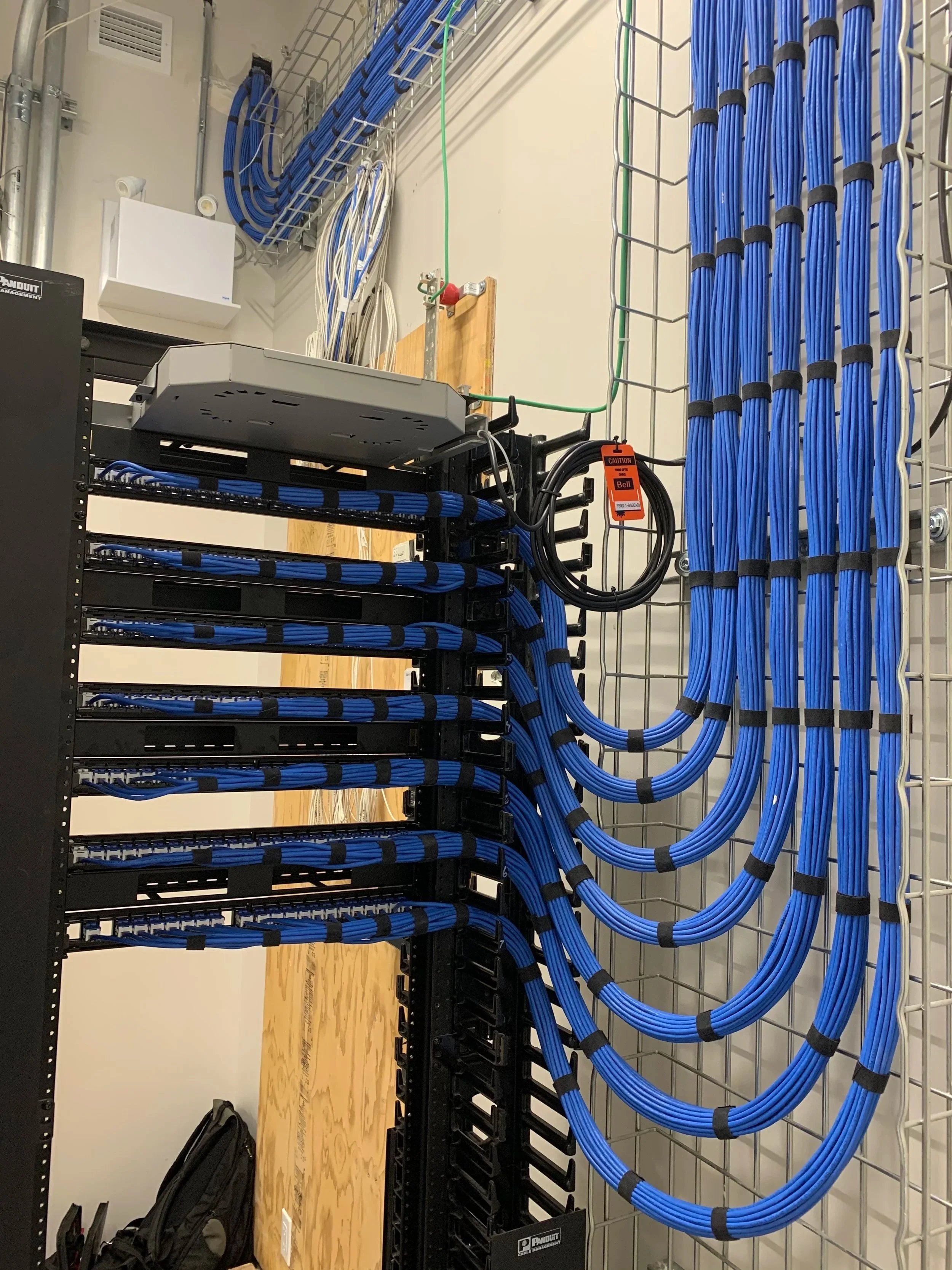 Structured cabling installation in Calgary office with 160+ data drops, including Cat6 cabling, patch panels, and organized network rack build.