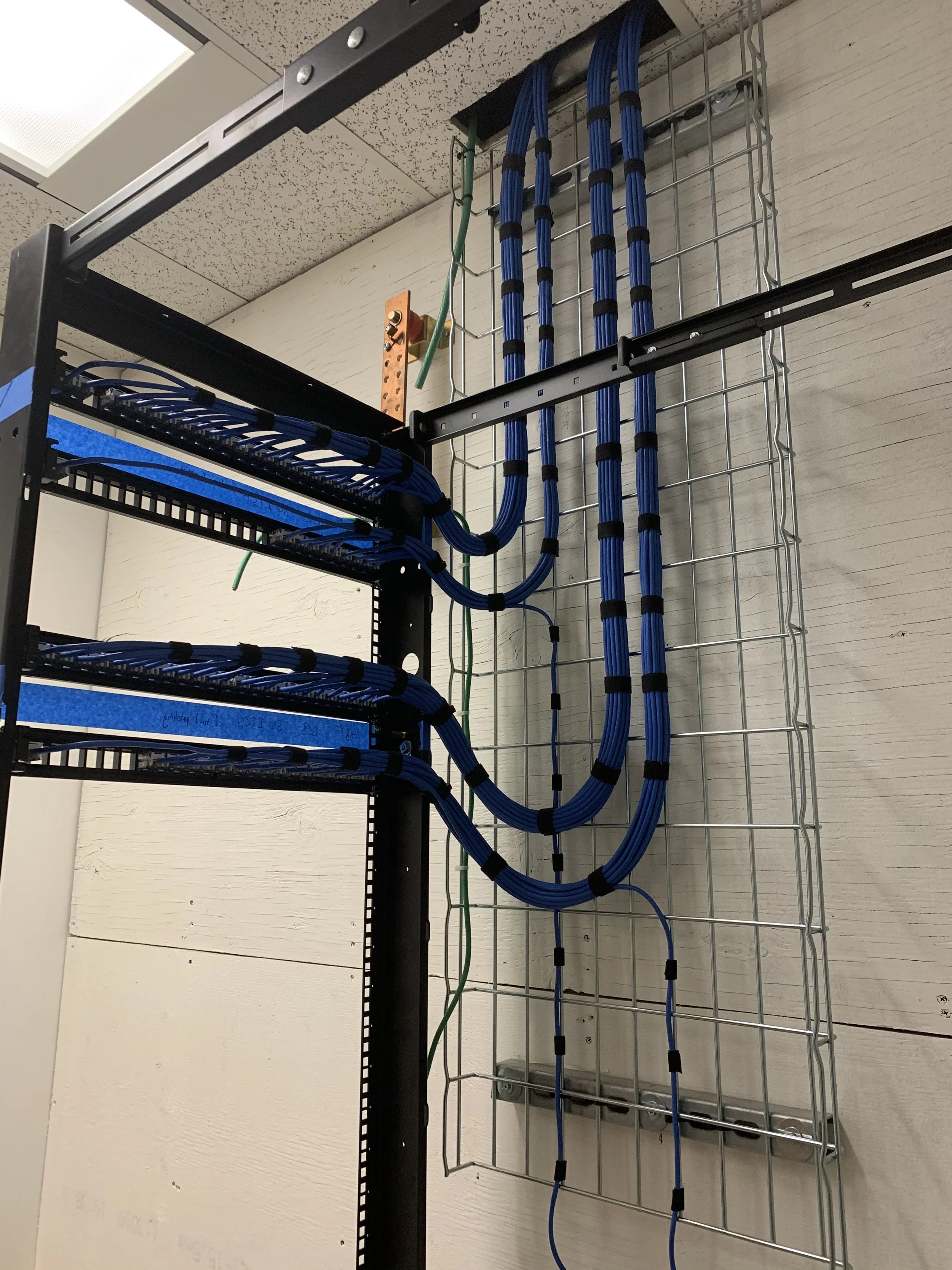 Commercial data cabling project in Calgary with 100 data drops, including cable routing, terminations, and clean cable management.