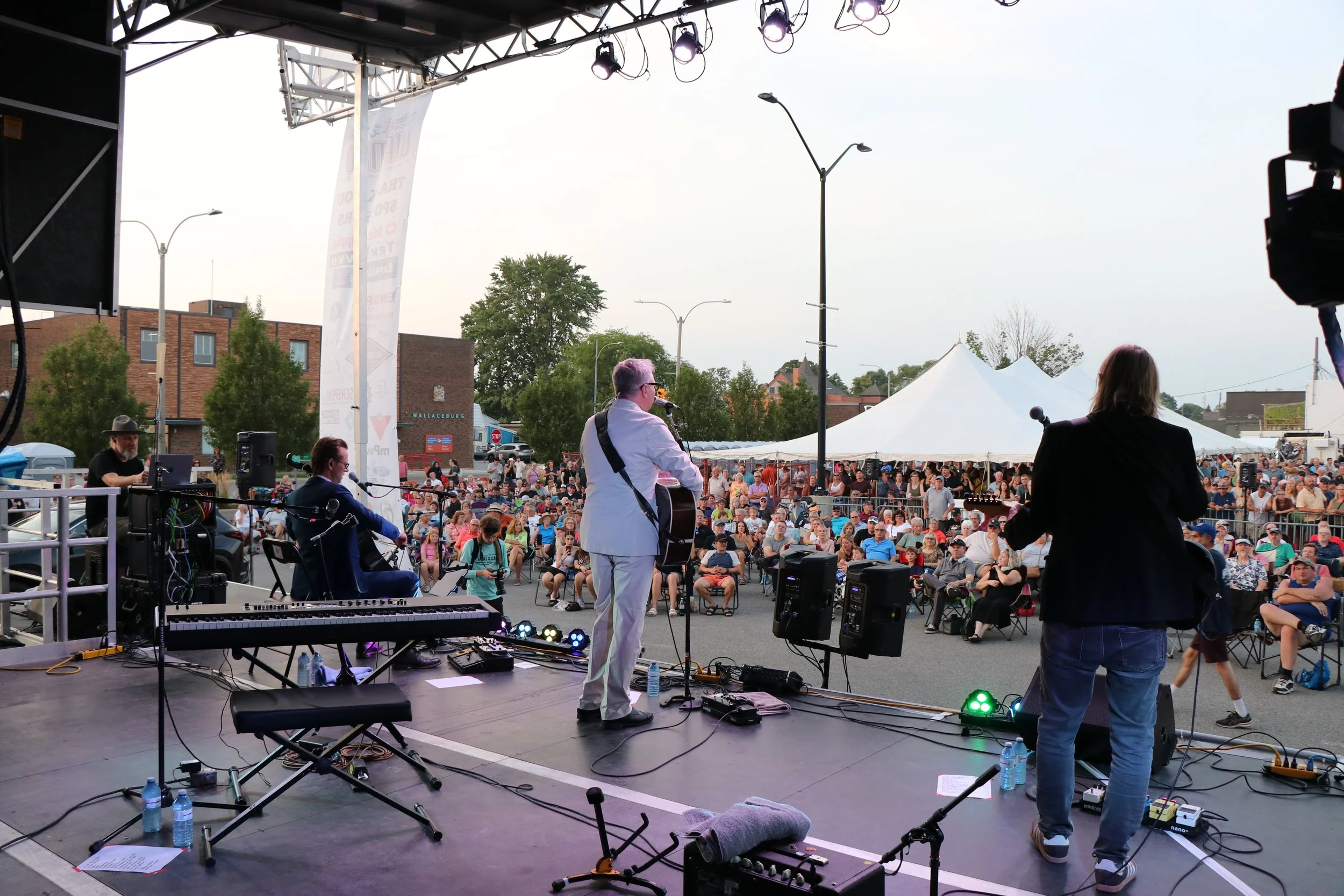Canadian musician and singer Steven Page with band performing on main stage to large crowd at WAMBO