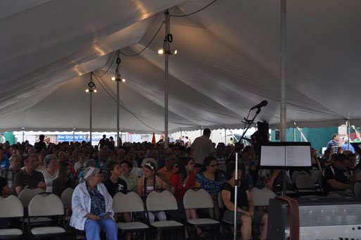 Big white event tent set up for a Sunday morning interdenominational service for local and visitors of WAMBO