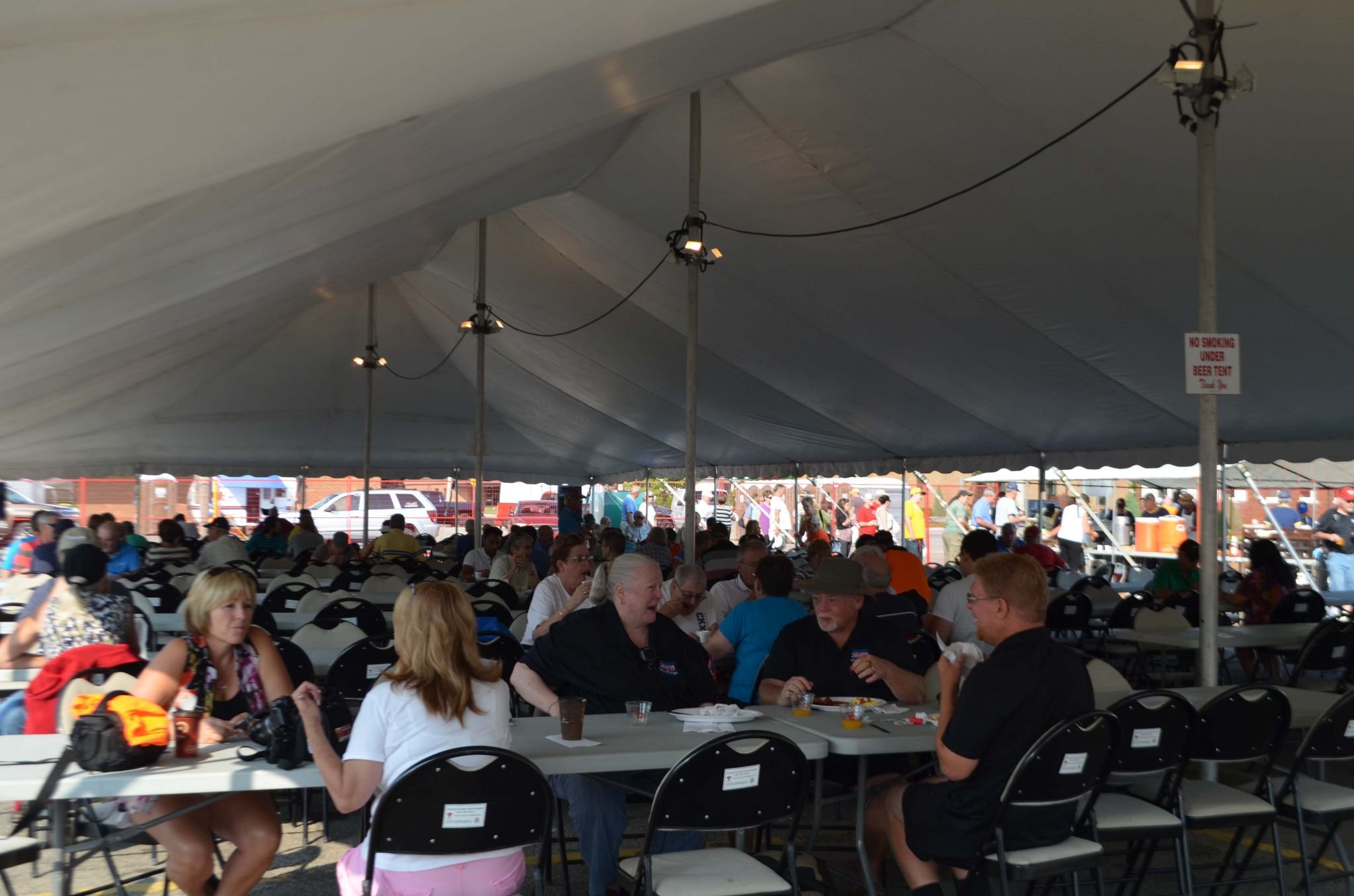 Big white event tent with rows and rows of tables and chairs set up with lots of people seated eating the Saturday morning breakfast at WAMBO hosted by the Knights of Columbus in Wallaceburg