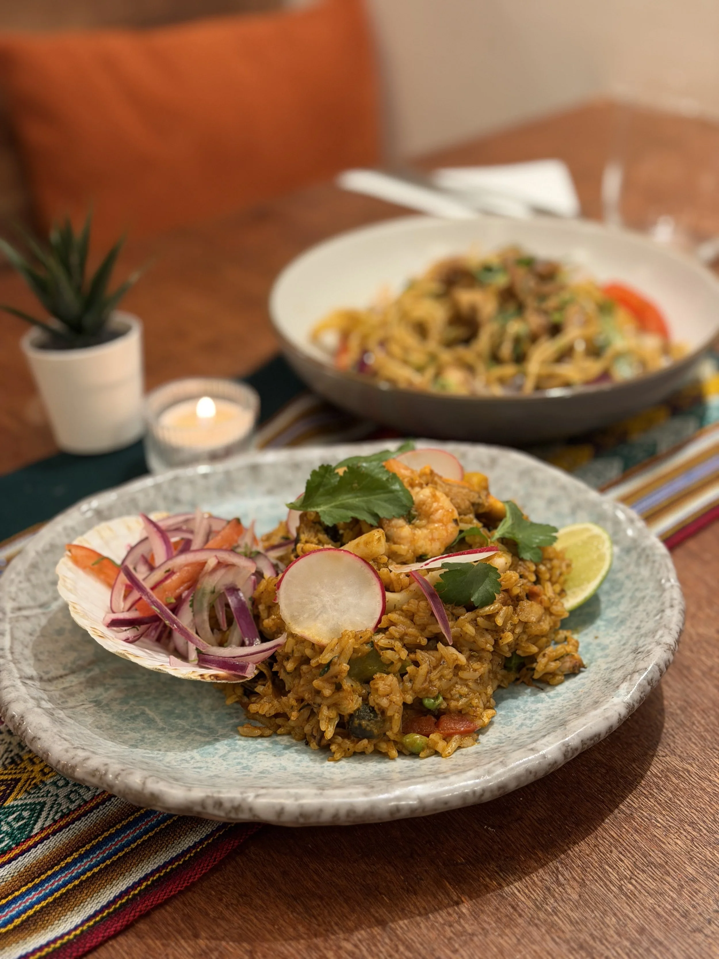 Peruvian arroz marino seafood rice with tallarín saltado in background at MAKA London