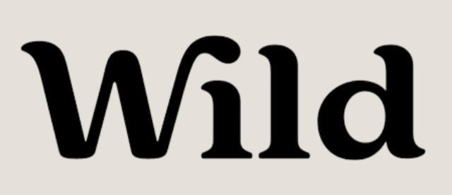 Close-up of the word 'Wild' written in black lowercase letters on a beige background.