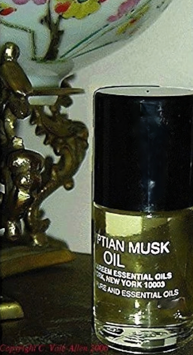 A bottle of Abdul Kareem Egyptian Musk™ oil essential oil next to a decorative enamel bowl owned by Charlotte Vale Allen