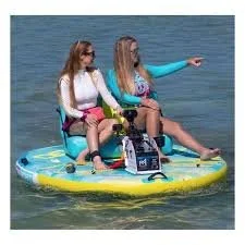 Two women sitting on an inflatable boat in a lake, one pointing at something in the distance.