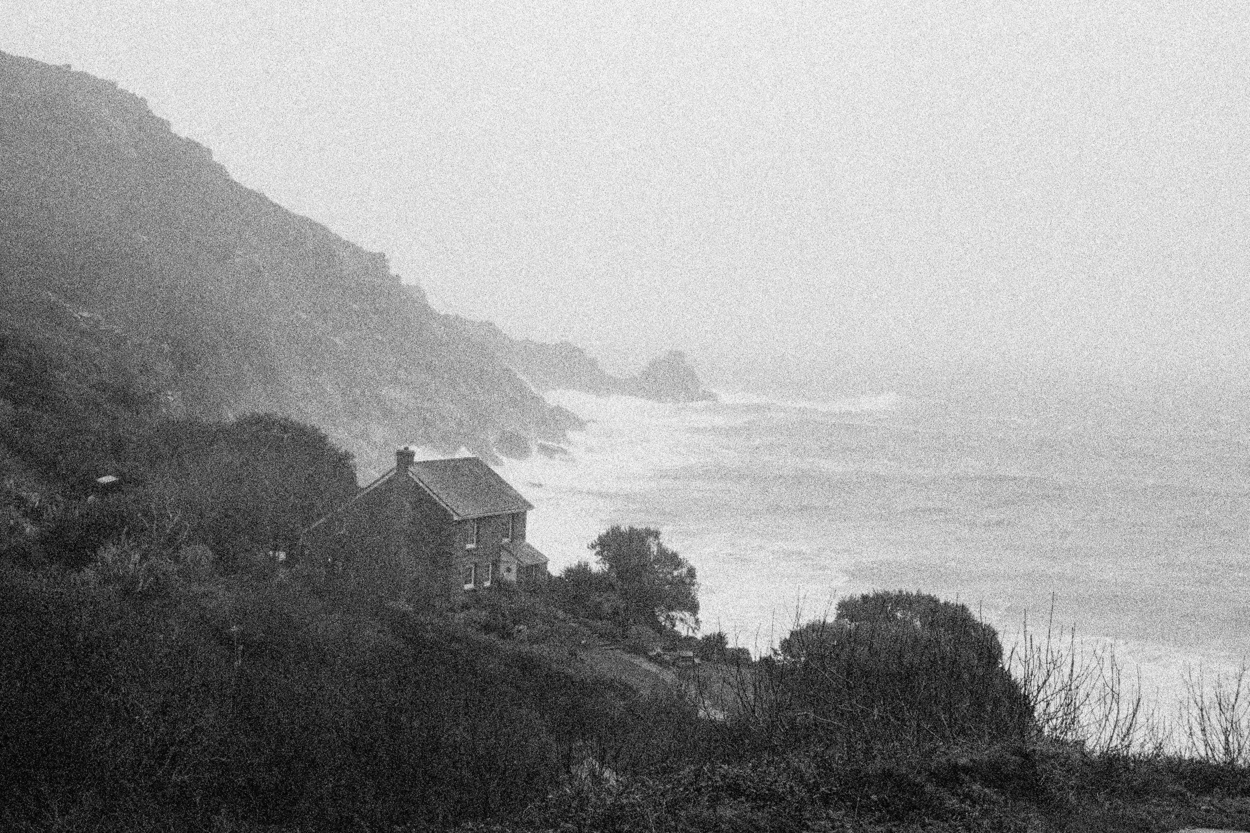 A cottage above the storm surf in heavy weather