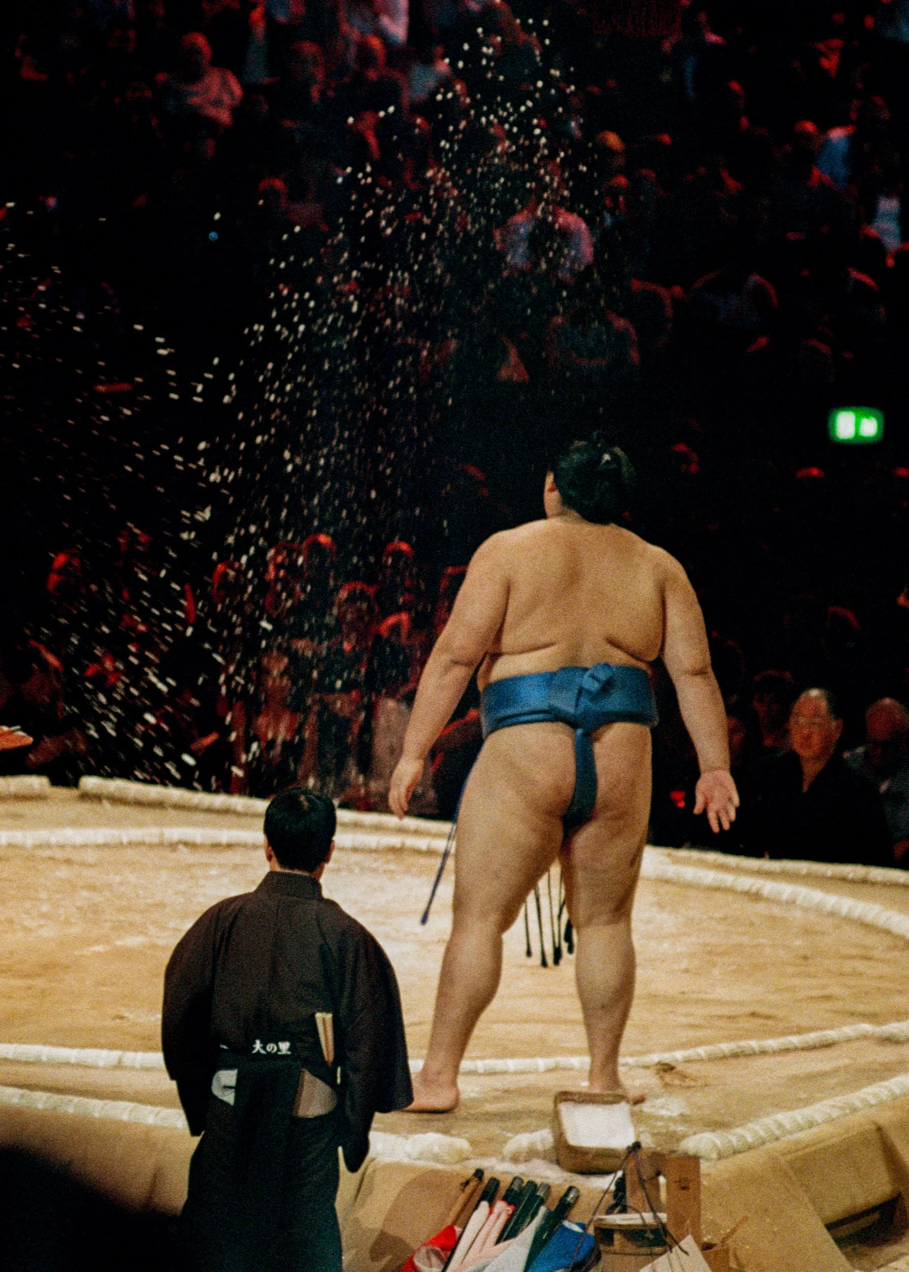 A sumo wrestler throws salt into the air before a bout at the Royal Albert Hall