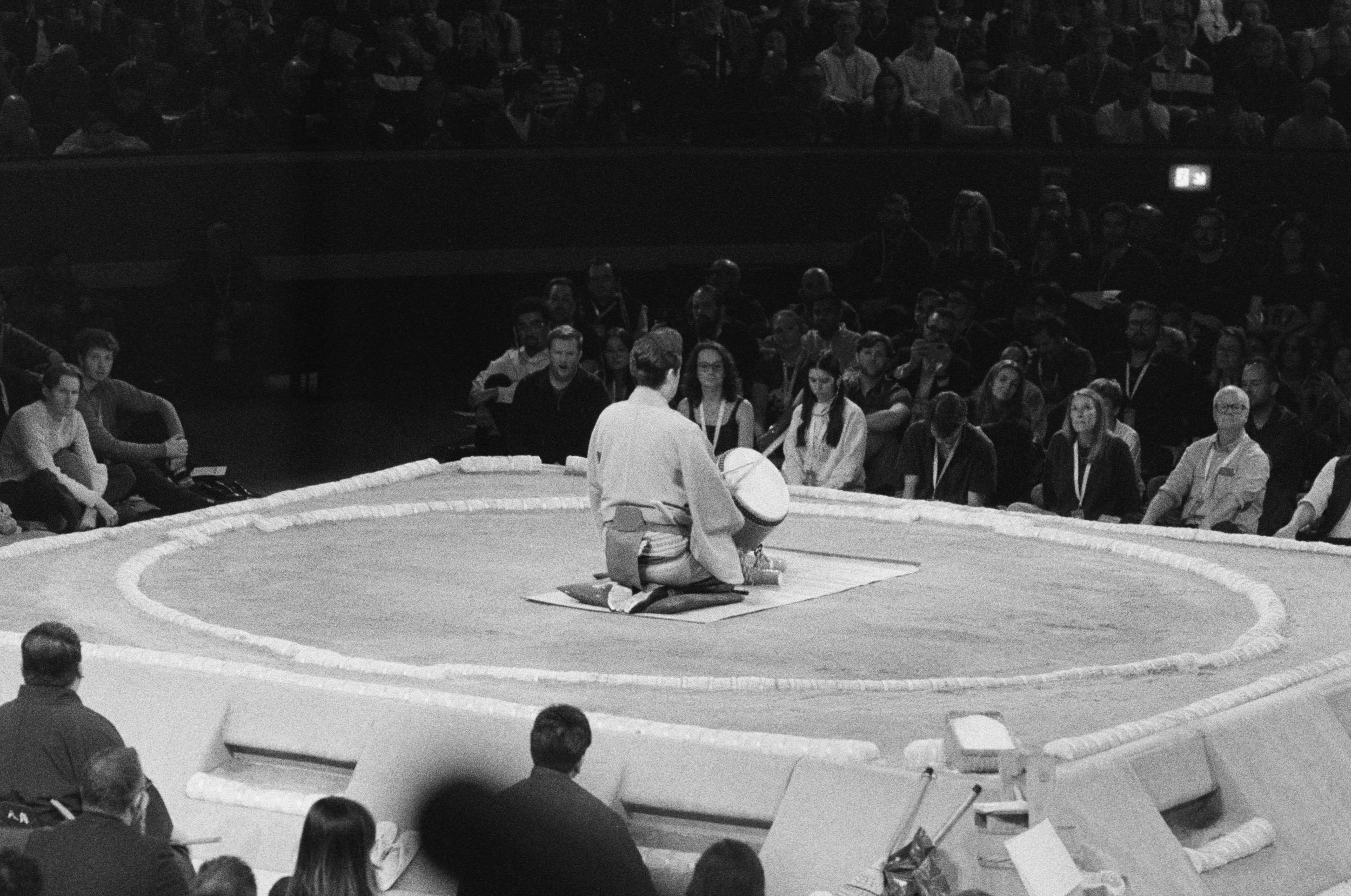 The drummer alone beside the dohyo before a full house