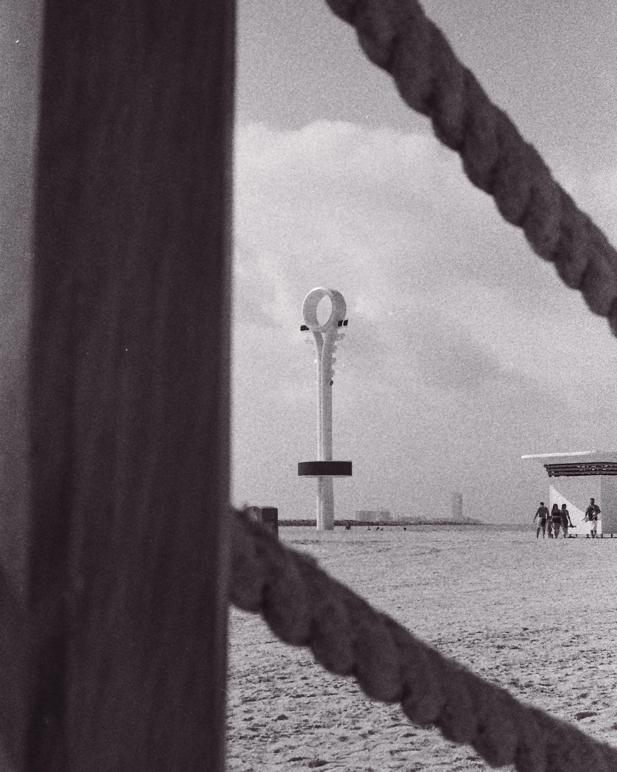 The lifeguard watchtower seen through the rope boundary of the family beach