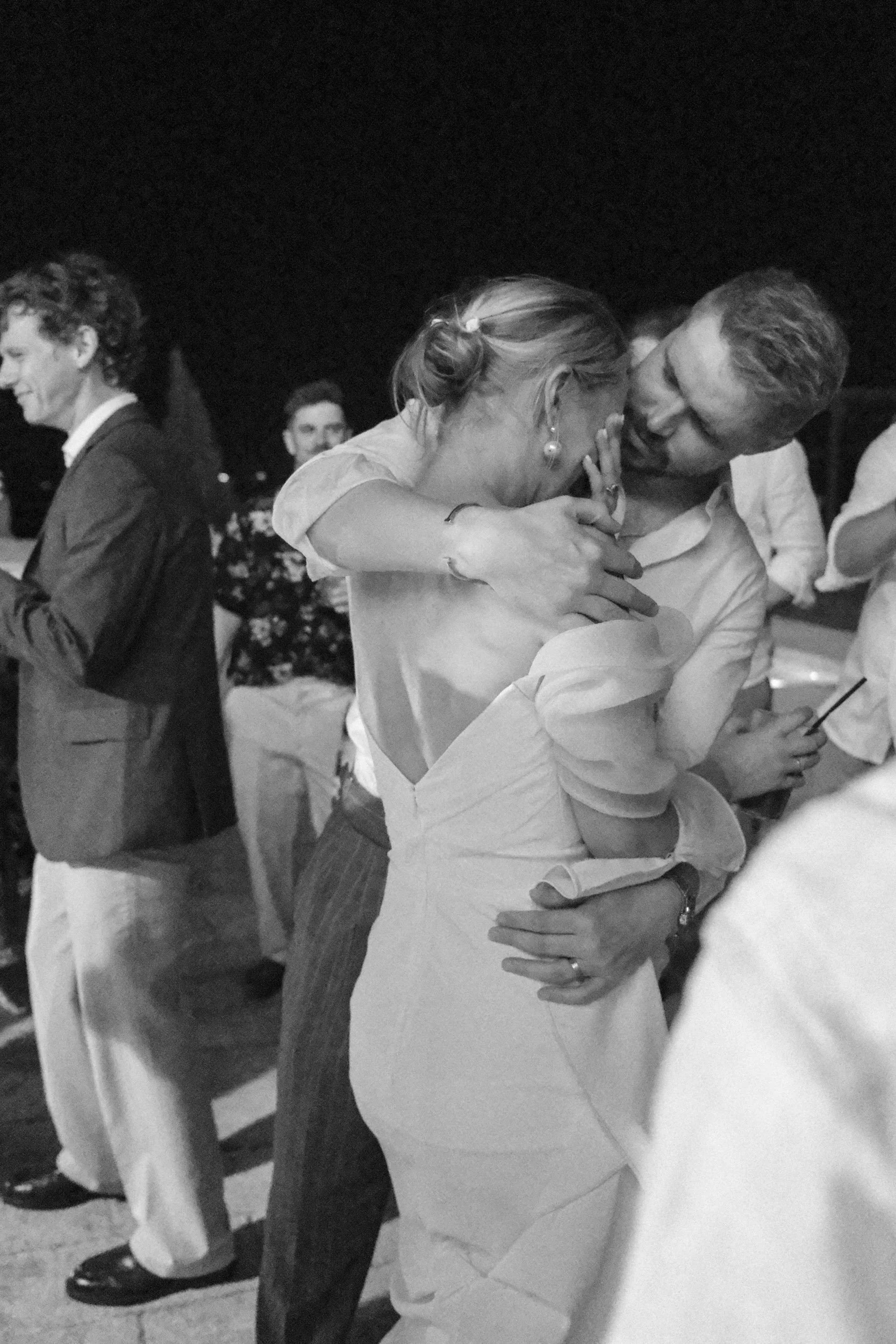 Groom cradling the tearful bride on the dancefloor