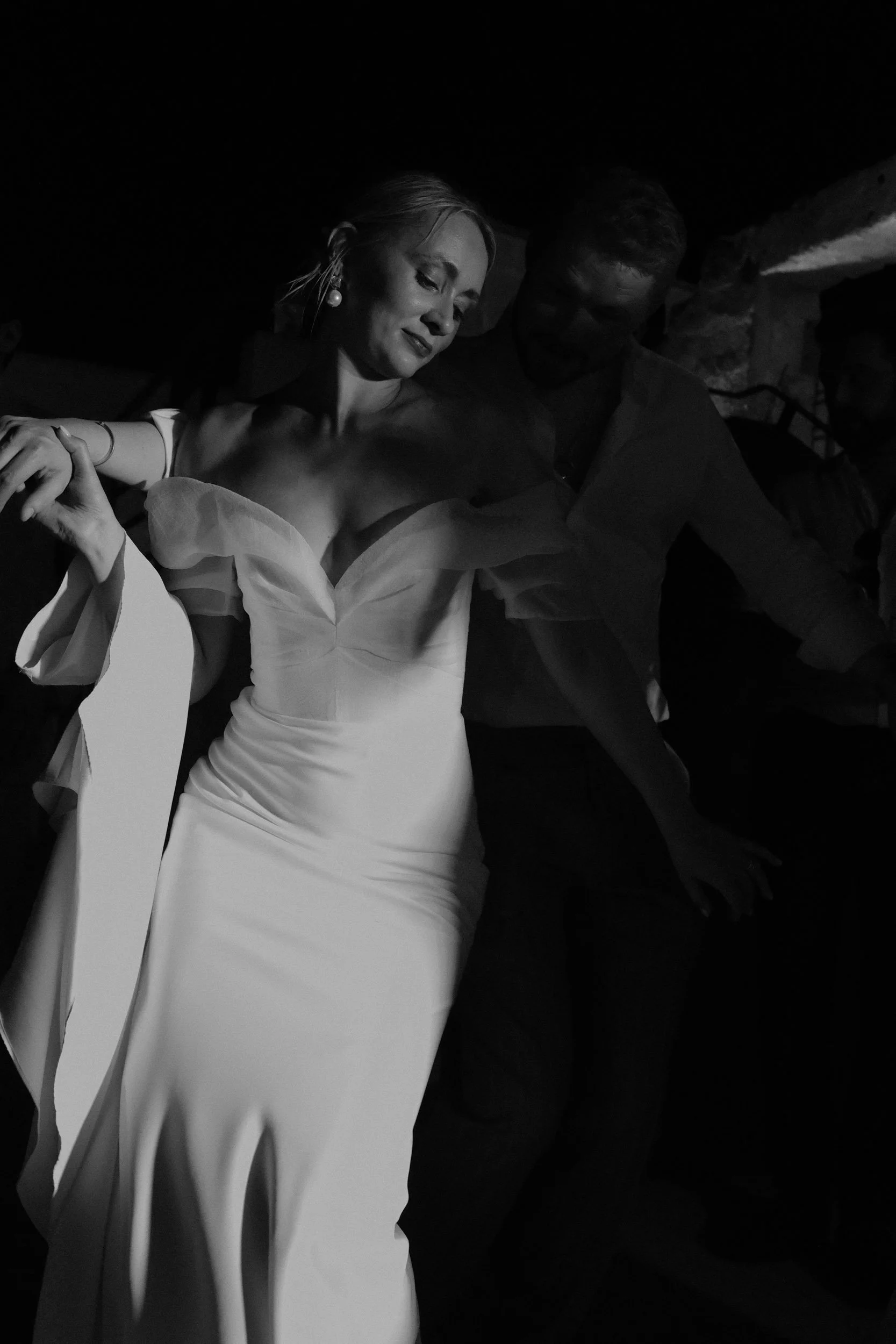Bride dancing in hard side light at a wedding in Puglia